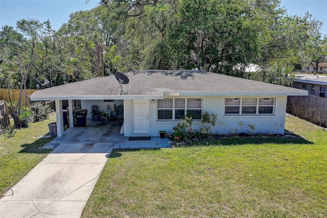 single story home featuring fence, a carport, concrete driveway, and a front lawn