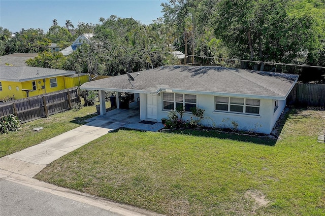 single story home featuring an attached carport, stucco siding, a front yard, and concrete driveway
