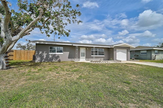 ranch-style house with a garage, a front yard, fence, and driveway