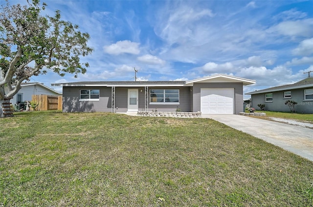 ranch-style house with a front lawn, fence, driveway, and an attached garage