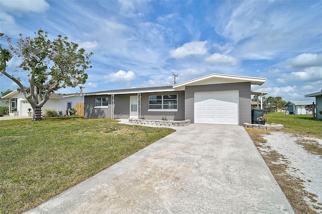 ranch-style home with a front yard, concrete driveway, and an attached garage