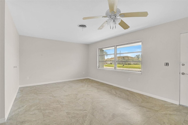 empty room featuring visible vents, ceiling fan, and baseboards