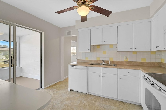 kitchen with white appliances, visible vents, a sink, and a healthy amount of sunlight