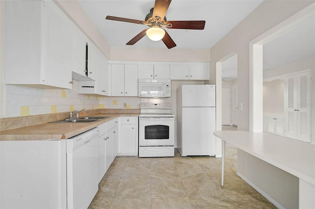 kitchen with white appliances, white cabinetry, a sink, and backsplash