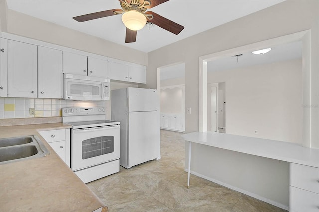 kitchen featuring white appliances, white cabinets, ceiling fan, light countertops, and backsplash