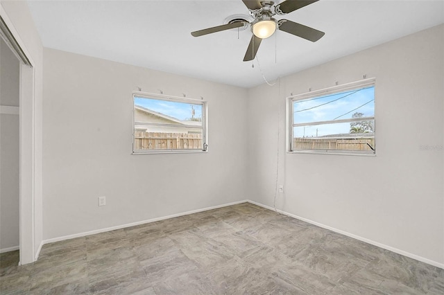 unfurnished room with a healthy amount of sunlight and baseboards