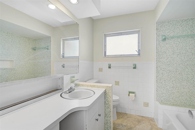 bathroom with a washtub, tile walls, toilet, a tile shower, and tile patterned flooring