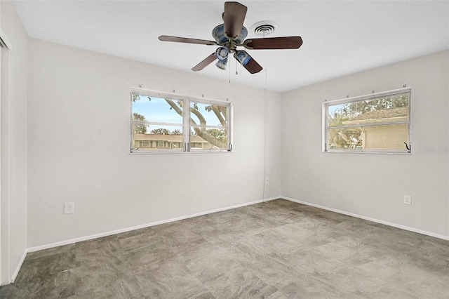 empty room featuring visible vents, plenty of natural light, and baseboards