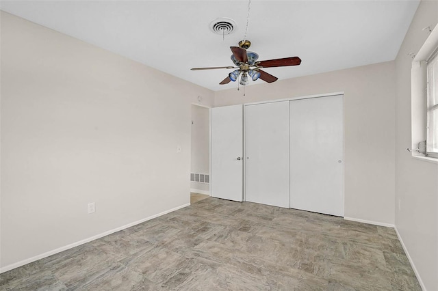 unfurnished bedroom with a closet, visible vents, and baseboards