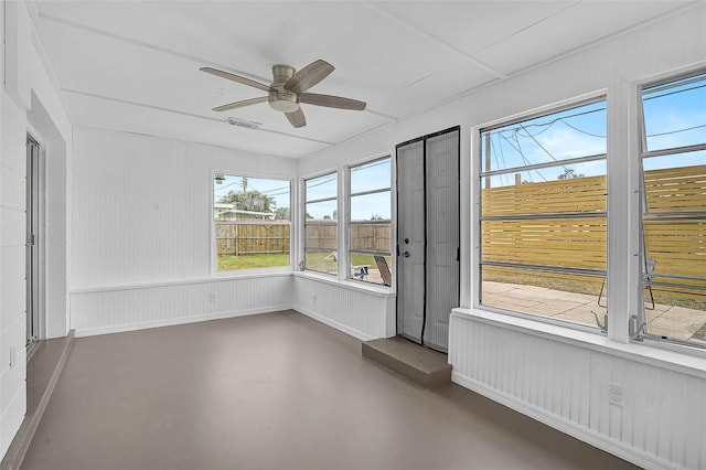 unfurnished sunroom with a ceiling fan