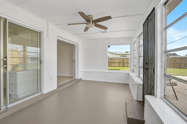 unfurnished sunroom with visible vents and ceiling fan