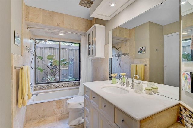 bathroom with vanity, tiled bath, a tile shower, and toilet