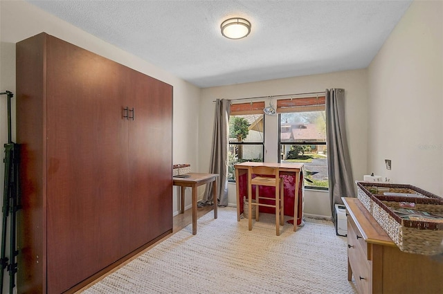 office featuring a textured ceiling and baseboards