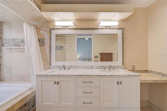 bathroom with double vanity, tiled bath, a sink, and tiled shower