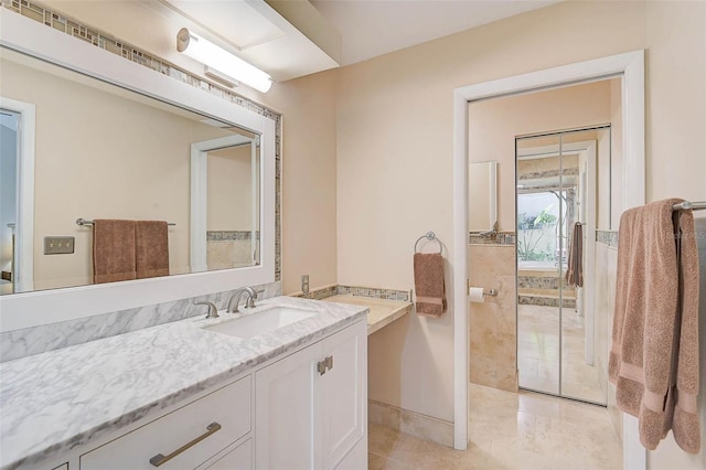 bathroom featuring tile patterned flooring and vanity