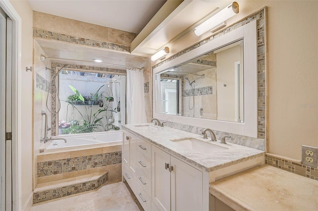 bathroom with a relaxing tiled tub, double vanity, a shower, and a sink