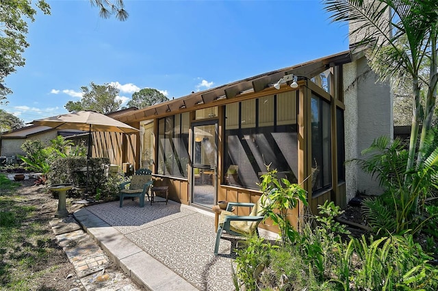 view of patio with a sunroom