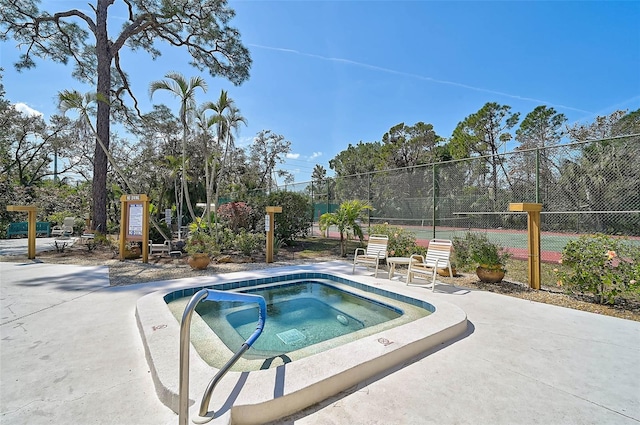 view of pool featuring fence and a hot tub