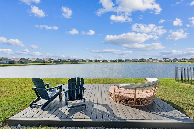 exterior space featuring a water view, a residential view, and a yard