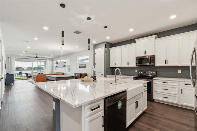 kitchen featuring an island with sink, appliances with stainless steel finishes, white cabinets, and dark wood-style flooring