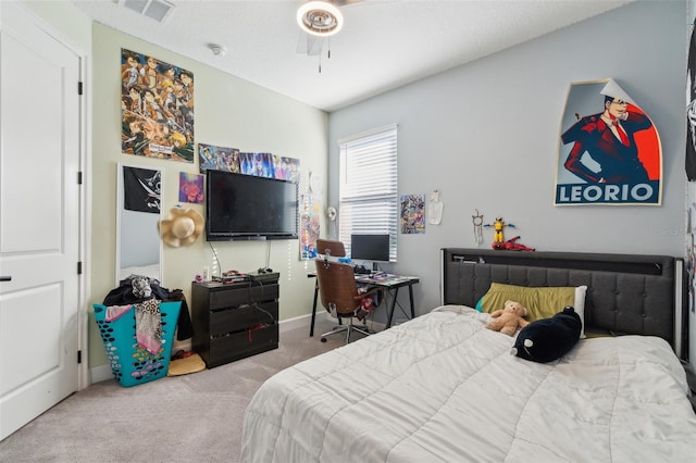 bedroom with baseboards, carpet floors, visible vents, and a ceiling fan