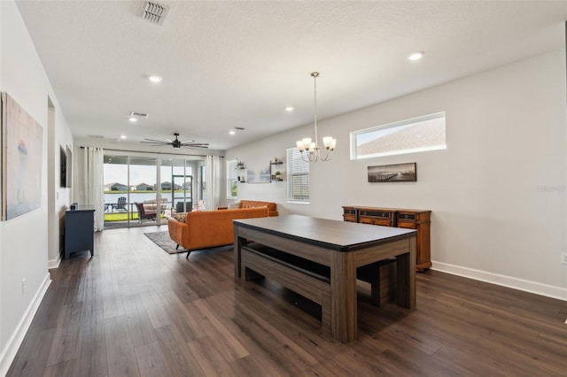 dining room with dark wood-style floors, visible vents, a textured ceiling, and baseboards