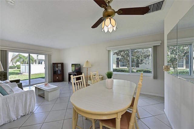 dining space with visible vents, ceiling fan, a textured ceiling, and light tile patterned flooring