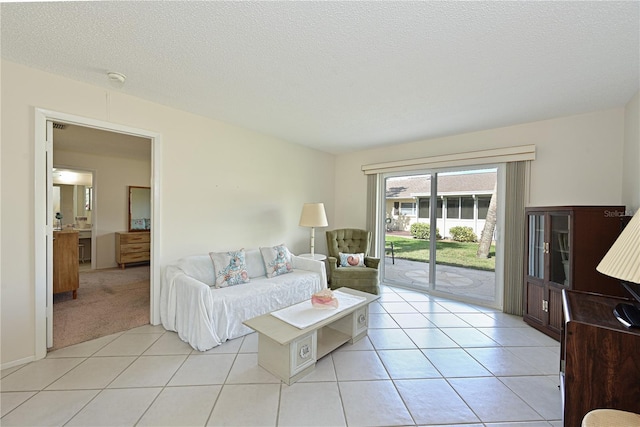 living area featuring a textured ceiling and light tile patterned floors