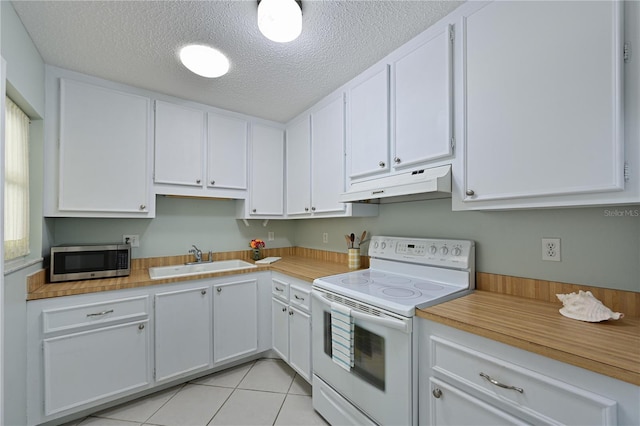 kitchen featuring white electric range oven, stainless steel microwave, white cabinets, a sink, and under cabinet range hood