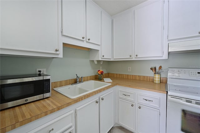 kitchen featuring premium range hood, a sink, white cabinetry, stainless steel microwave, and white electric range oven