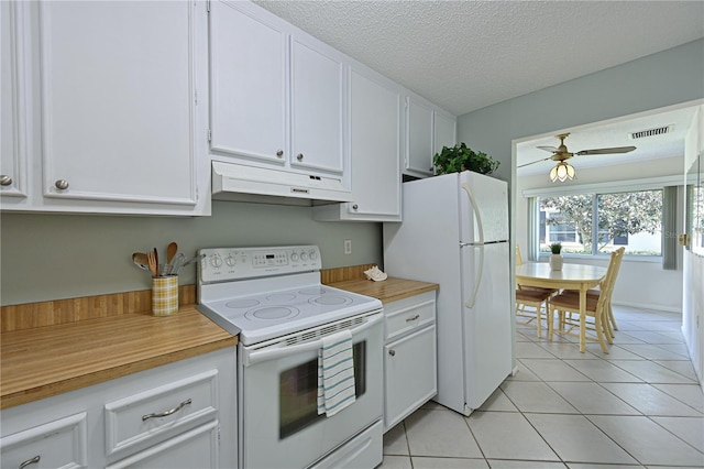 kitchen with white appliances, white cabinetry, under cabinet range hood, and light tile patterned floors