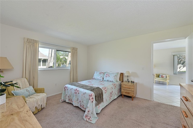 carpeted bedroom featuring a textured ceiling, tile patterned flooring, and baseboards