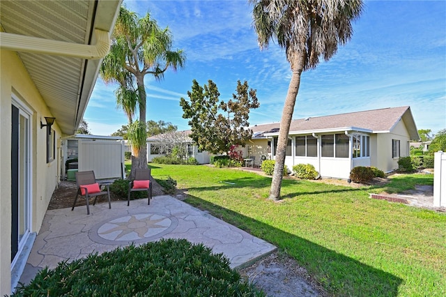 view of yard featuring a sunroom and a patio