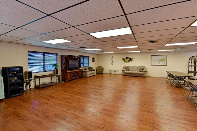 interior space featuring visible vents, wood finished floors, and a paneled ceiling