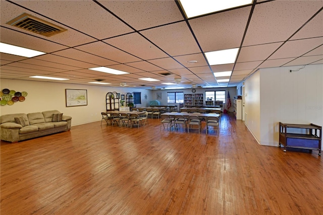 playroom featuring a paneled ceiling, visible vents, and wood finished floors