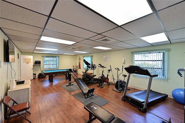 exercise room featuring a paneled ceiling, visible vents, wood finished floors, and pool table