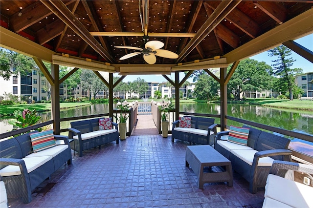 view of patio / terrace with an outdoor hangout area, a gazebo, ceiling fan, and a water view