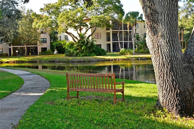 view of community with a water view and a lawn