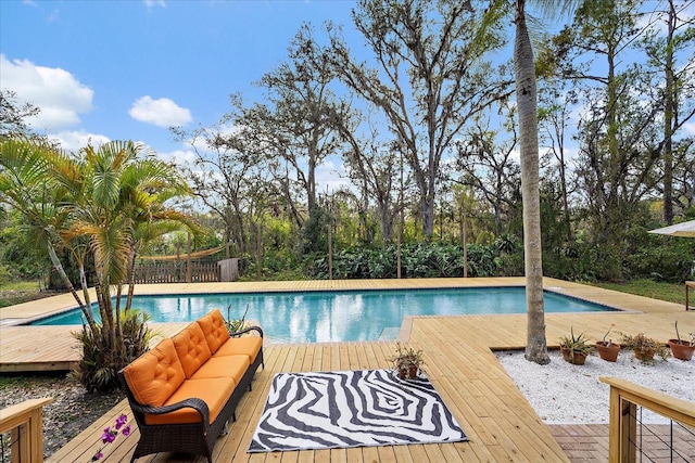 outdoor pool featuring an outdoor hangout area and a deck