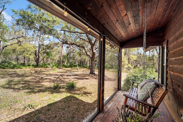 unfurnished sunroom featuring wooden ceiling and lofted ceiling