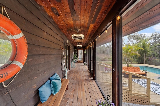 wooden deck with an outdoor pool