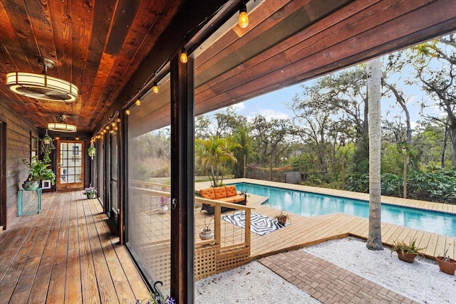 deck featuring an outdoor pool