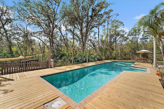 outdoor pool featuring a patio area and a wooden deck