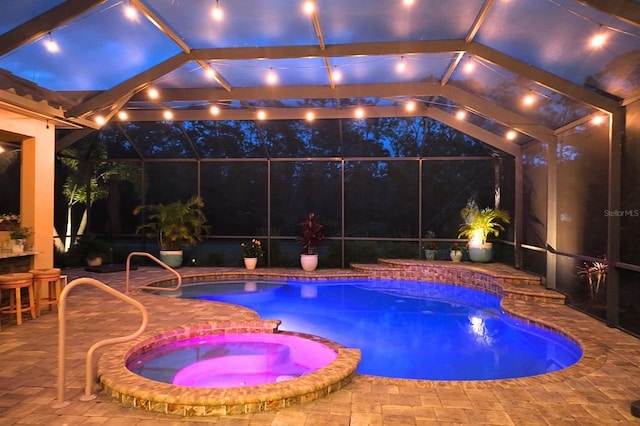 view of pool featuring a pool with connected hot tub and a patio area