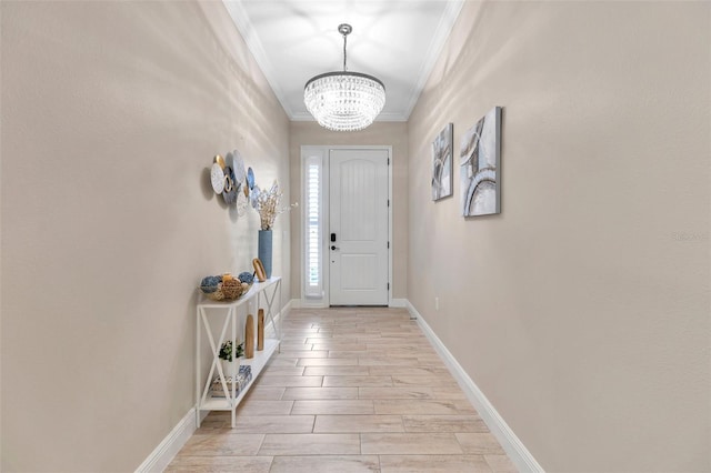 doorway to outside featuring an inviting chandelier, wood tiled floor, ornamental molding, and baseboards