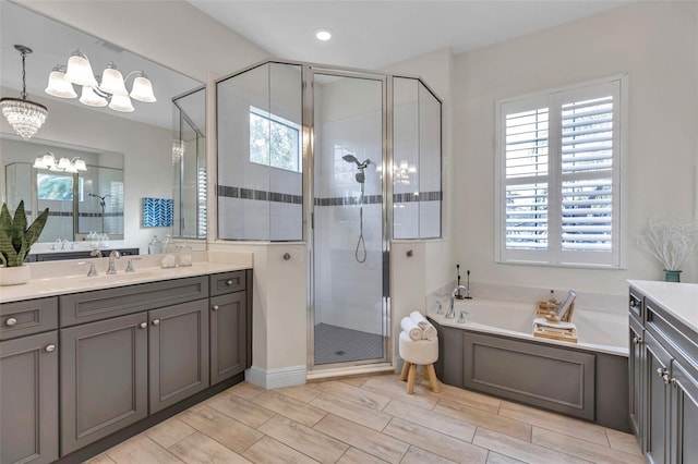 full bathroom with a stall shower, a bath, and vanity