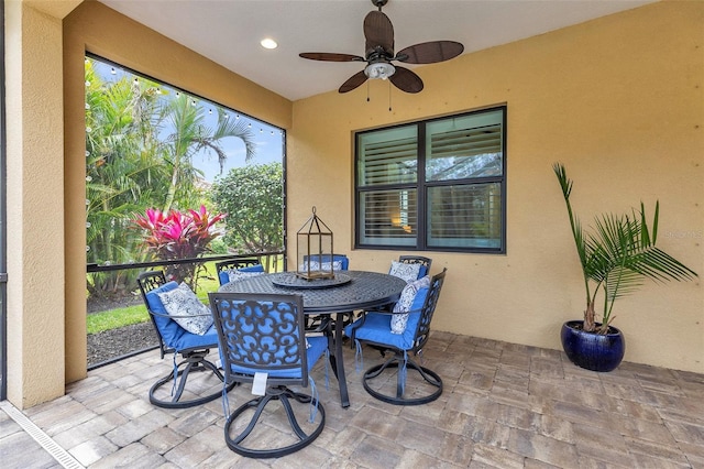 sunroom featuring a ceiling fan