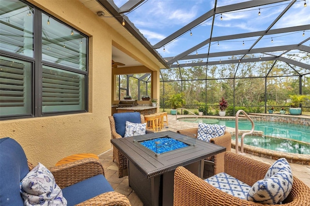 view of patio / terrace featuring a fire pit, a lanai, and an outdoor pool