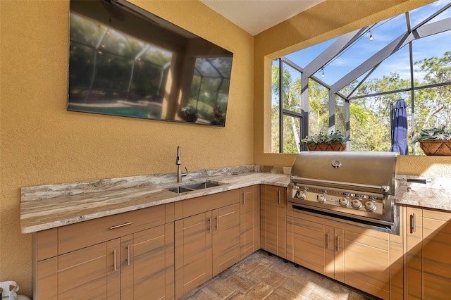 kitchen featuring a textured wall, a sink, and a sunroom