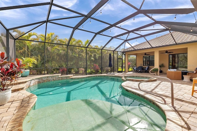 outdoor pool featuring a ceiling fan, a lanai, a patio area, and an in ground hot tub